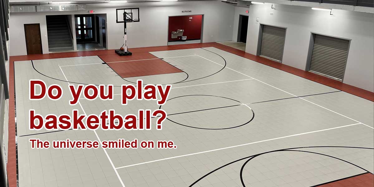 A view of a basketball court in a gym. 